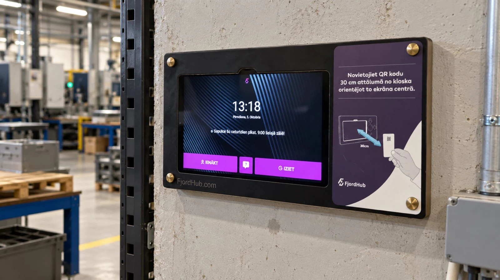 FjordHub camera kiosk: a tablet in a wall mount in a factory hall, showing the clock and the clock in and clock out buttons, with a sign showing how to hold the QR code